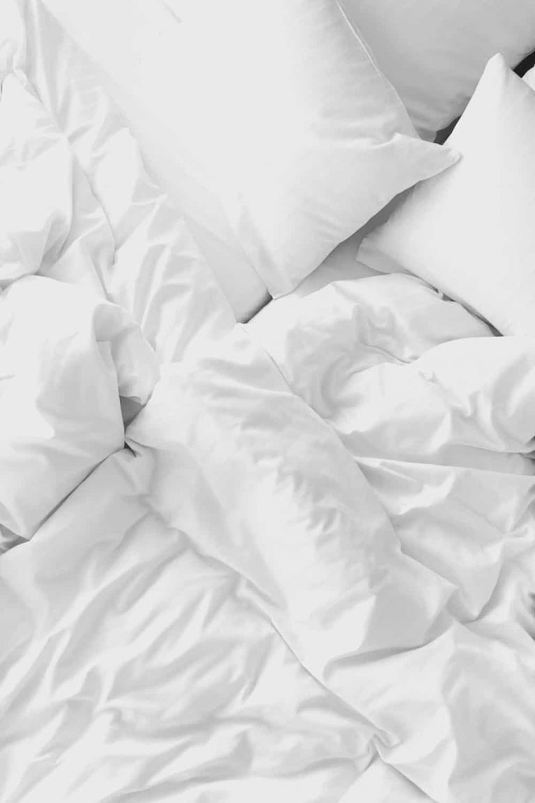 Luxurious white bed with pillows and duvet at Catherines of Partick.