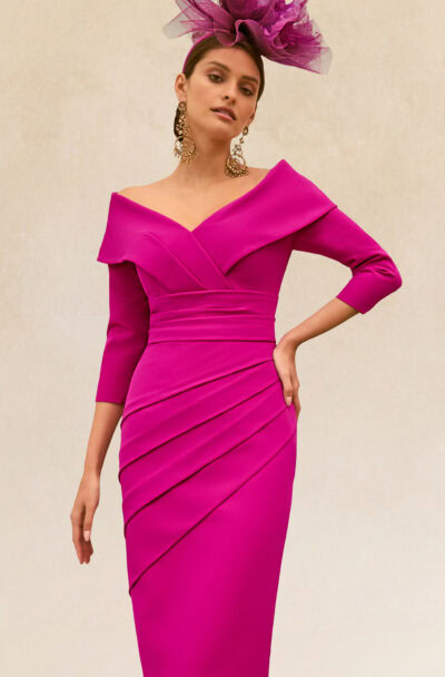 A woman in an elegant magenta dress and fascinator.
