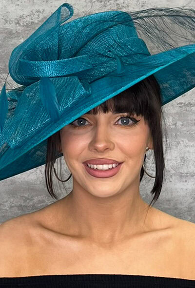 Stylish blue hat with bow detail, perfect for special occasions.