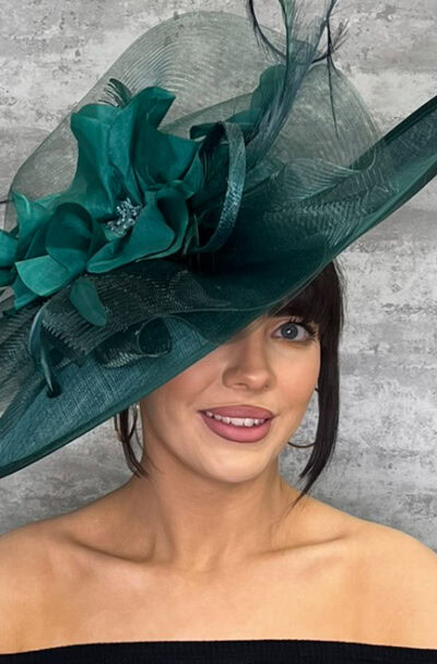 Stylish green hat with statement flower and netting for special occasions.