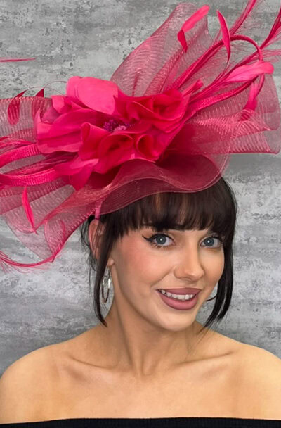 Pink hatinator with feathers and netting for special occasions.