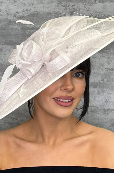 Large white hat with statement loops and floral details for special occasions.