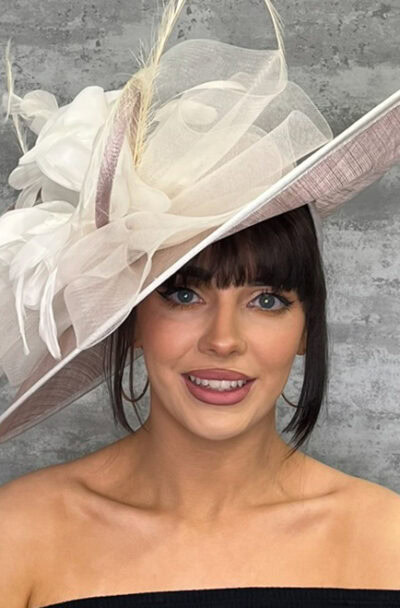 Stylish large hat with feather quills and floral accents for special occasions.