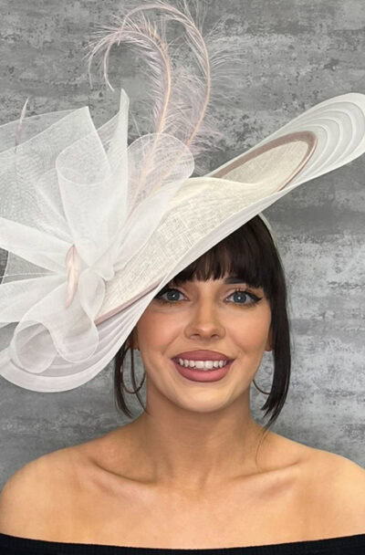 Elegant large hatinator with crin trim and feather details for special occasions.