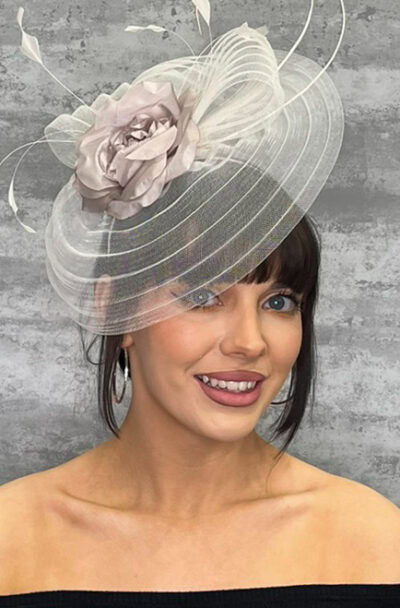 Stylish small hat with veiling and floral decoration for special occasions.