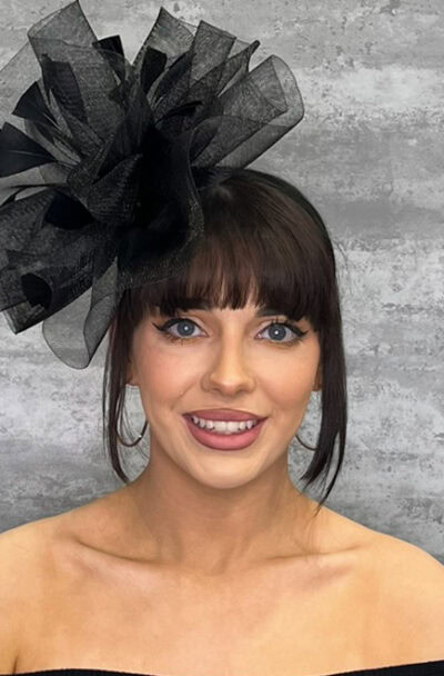 Small black hatinator with crinoline waves and feather accents for special occasions.