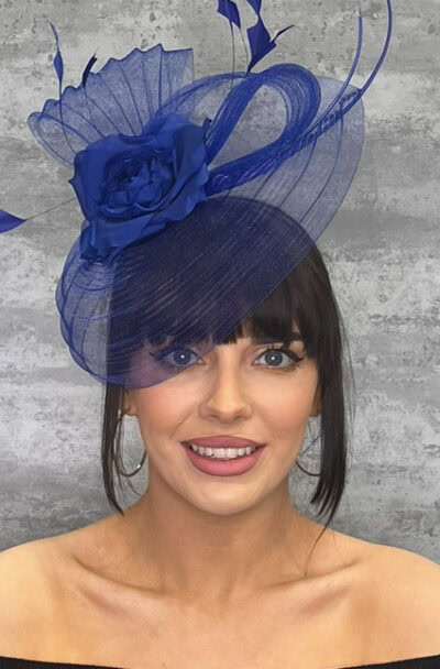 Elegant blue hatinator with crin veil and floral detail for special occasions.
