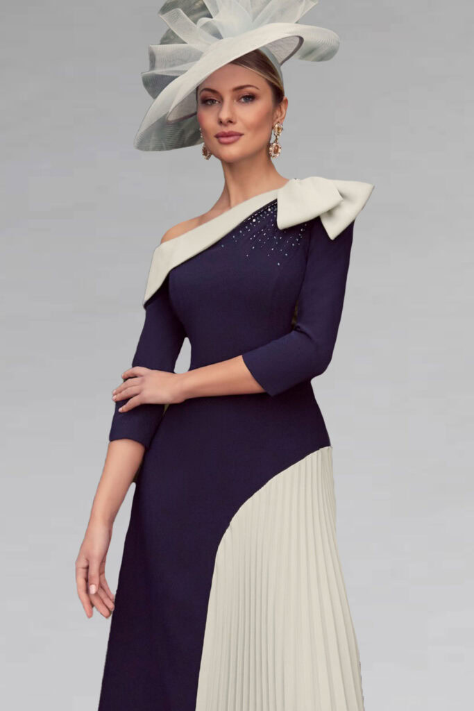 Elegant navy and cream dress with asymmetric hemline and bow detail, perfect for special occasions.