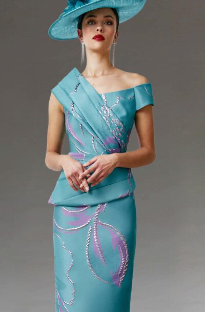Woman in an elegant turquoise dress and matching hat.