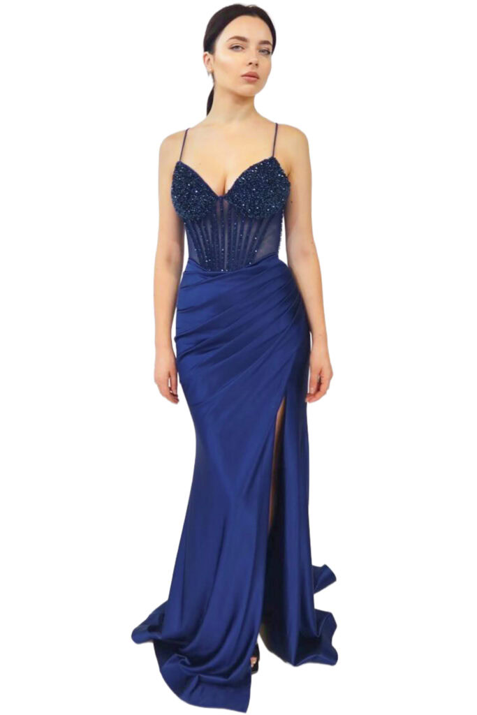 A woman models a navy blue beaded corset evening gown.