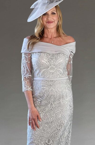 A woman in an elegant silver embellished dress and hat.