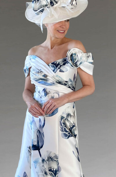 A woman in an elegant blue and white floral dress.