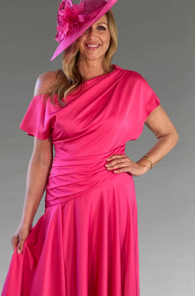 A woman in a vibrant pink dress and matching hat.