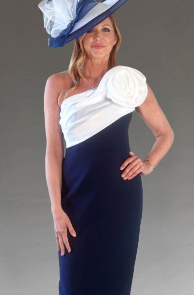 Elegant woman in a navy dress and large fascinator hat.