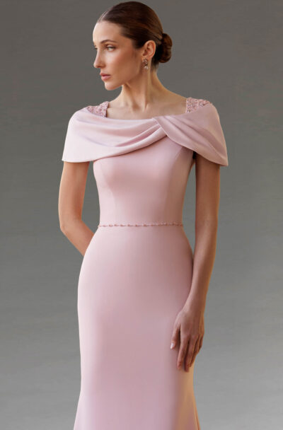 A woman wearing an elegant pale pink evening gown.