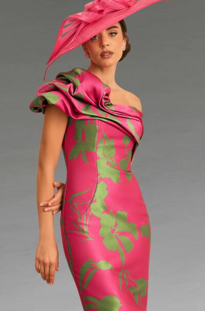 A woman in a pink floral dress and matching fascinator.