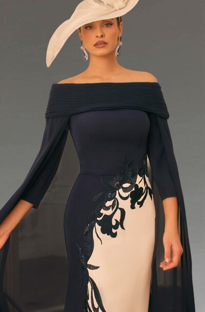 Woman in elegant navy dress with large cream hat.