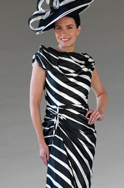 A woman in a striped monochrome dress and hat.