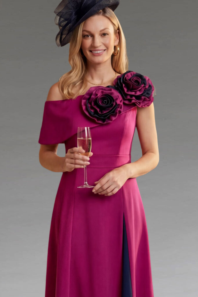 Woman in an elegant magenta dress and navy fascinator.
