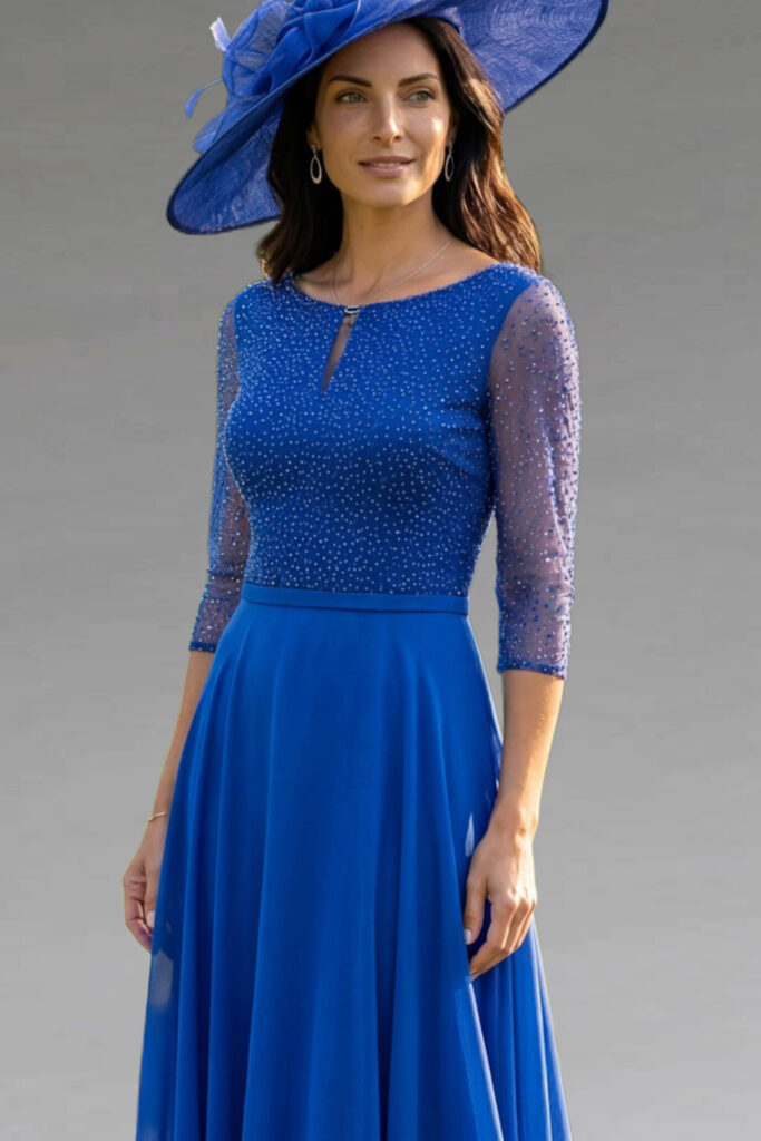 A woman wearing an elegant royal blue dress and hat.