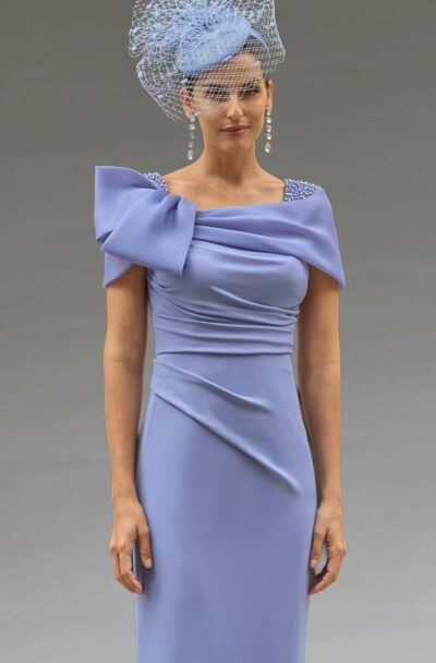 Woman in a periwinkle dress with a matching fascinator.