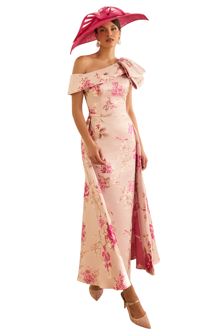 Woman in pink floral dress and matching large hat.