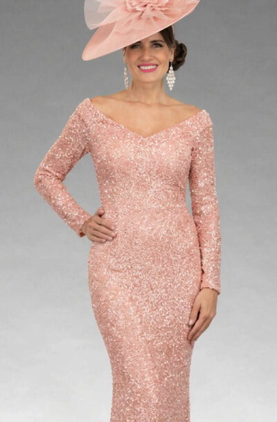A woman in a pink sequined dress and fascinator.