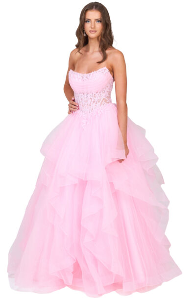 A young woman posing in a pink strapless ball gown.