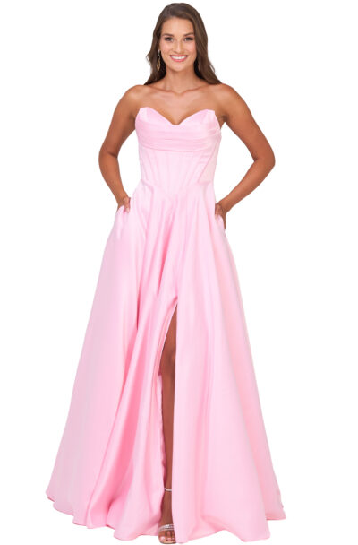 Woman smiling in a pink strapless gown with pockets.