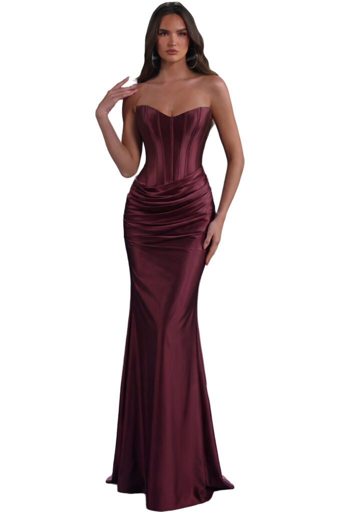 A woman models a burgundy strapless corset gown.