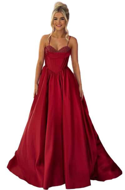 A woman wearing a stunning red corset ball gown.