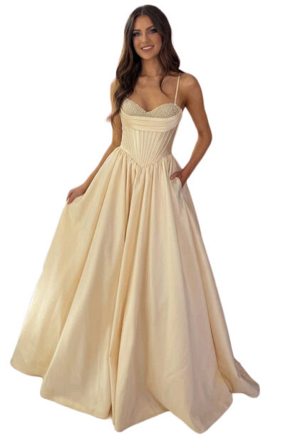 A woman wearing a cream pearl-embellished corset ball gown.
