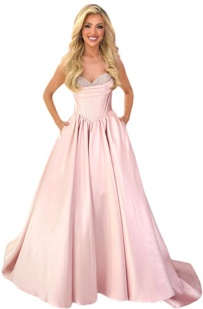 A smiling blonde woman in a pink ball gown.