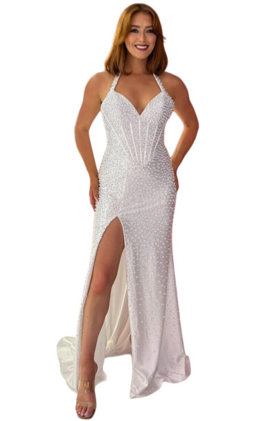 Woman in a white pearl-embellished halter neck evening gown.