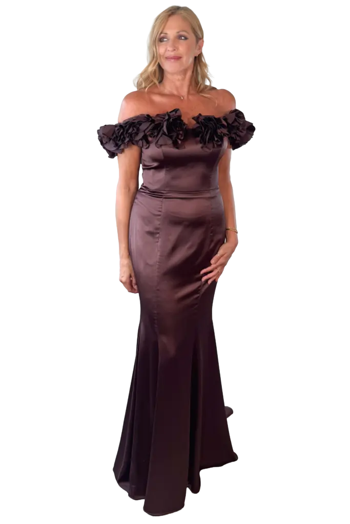 Woman in an elegant off-the-shoulder brown formal gown.