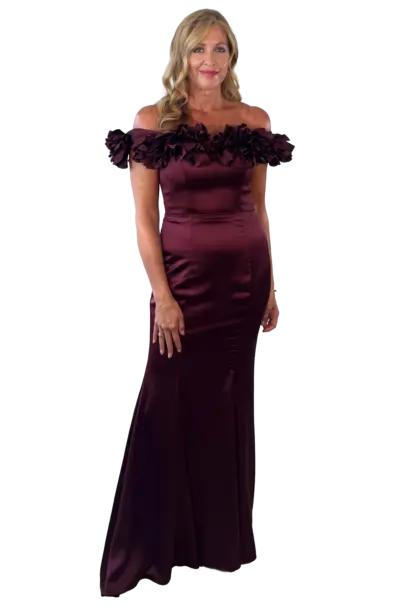 Woman in an elegant off-the-shoulder maroon evening gown.