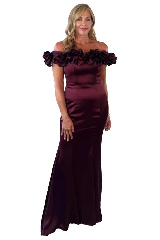 Woman in an elegant off-the-shoulder maroon evening gown.